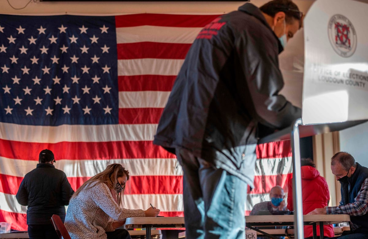 Voters flock to polling stations across America on election day as nation decides between Trump and Biden