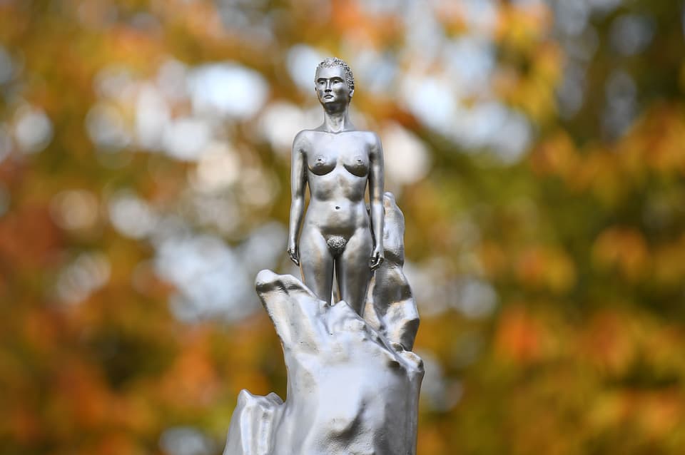 A picture shows a detail of a naked lady at the top of a new sculpture honouring 18th century British author and feminist icon Mary Wollstonecraft by British artist Maggi Hambling