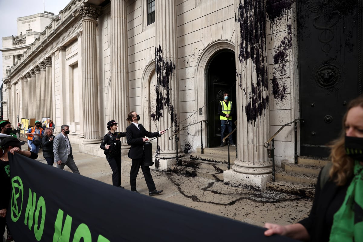 Extinction Rebellion activists spray black paint over Bank of England