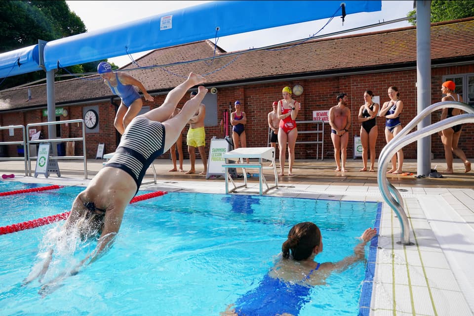 People take to the water for an early morning cool down at London Fields Lido, in Hackney, east London. A sweltering 34C (93.2F) is expected in London and potentially some spots in East Anglia on Friday, according to the Met Office. Picture date: Friday June 17, 2022. 