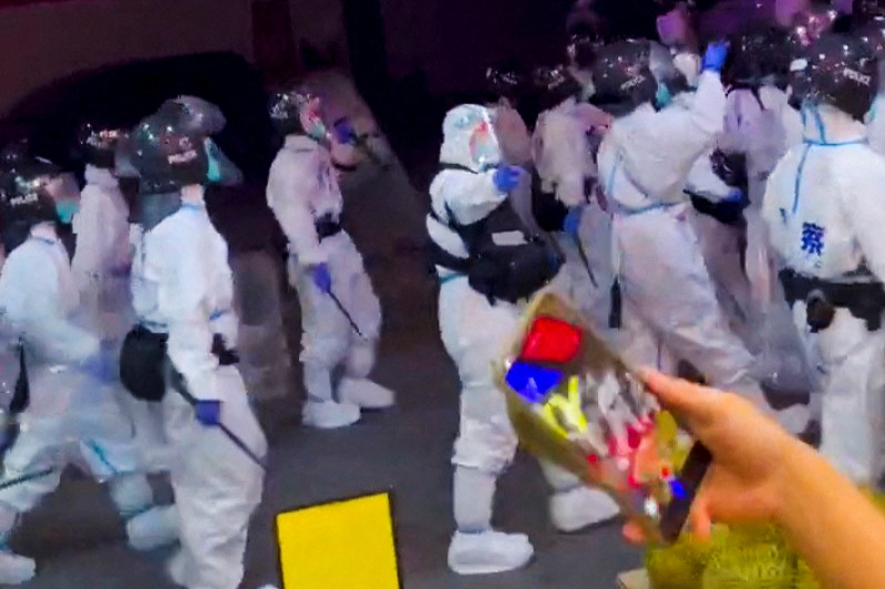 Crowds in Chinese city of Guangzhou clash with white hazmat-suited riot police 