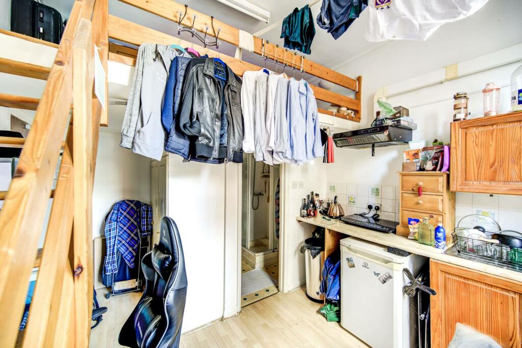 Earls Court studio with the bed in a storage area to rent for £1279pcm