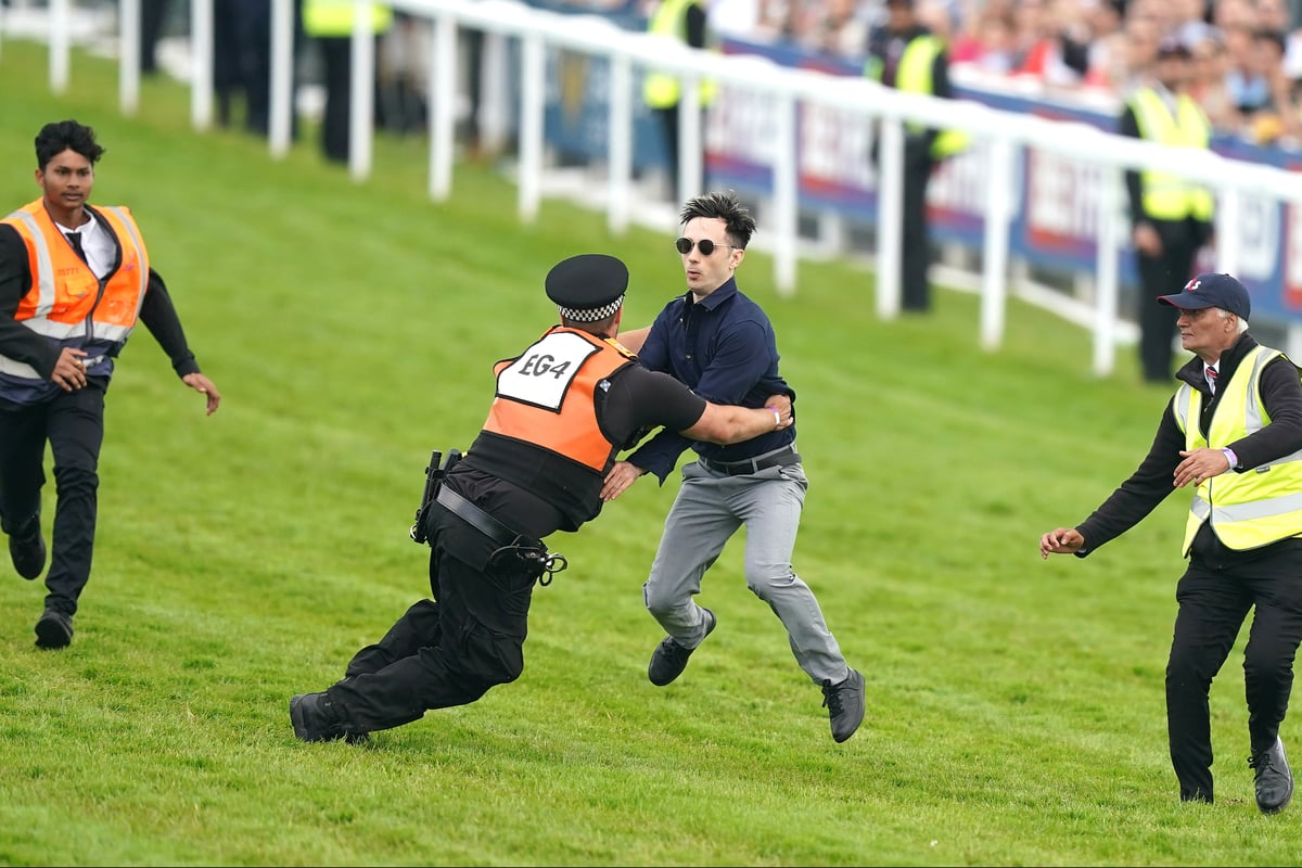 Activist arrested after storming racecourse at Epsom Derby