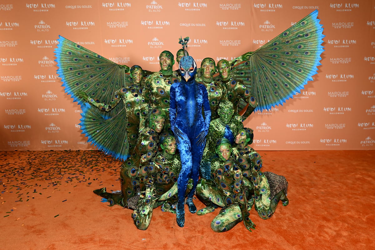 Heidi Klum is unrecognisable as she transforms into a peacock for her most elaborate Halloween costume yet
