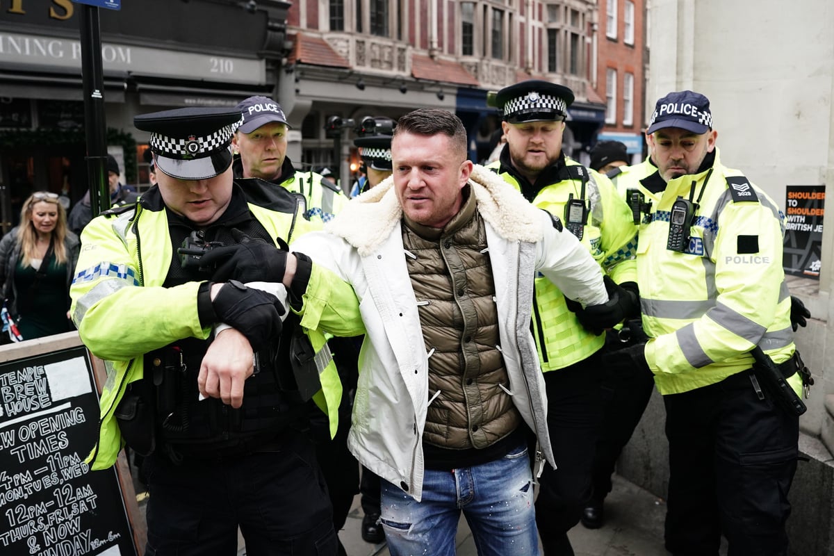 Tommy Robinson escorted from march against antisemitism as thousands gather