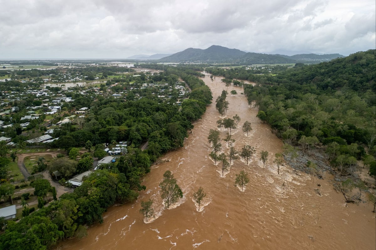 Desperate Australians risk wading through crocodile-infested floodwater to get to safety
