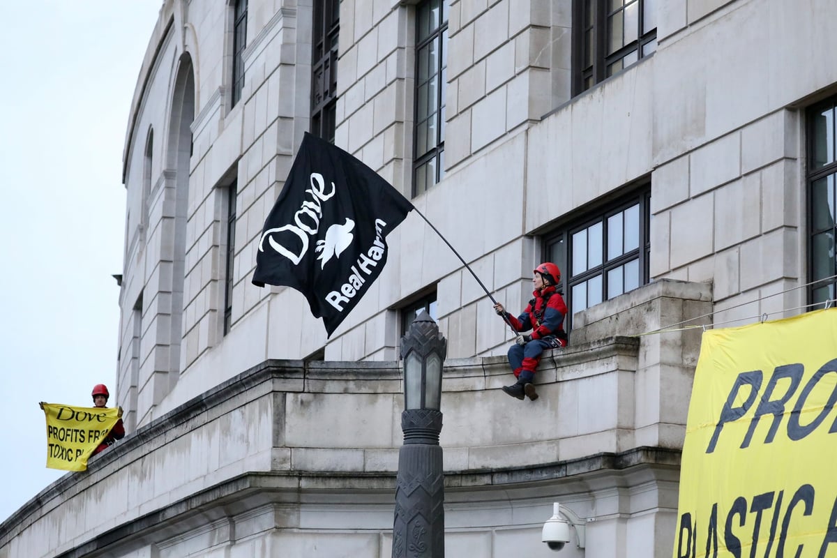 Greenpeace protesters scale Unilever headquarters in plastic pollution protest