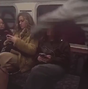 Police appeal after social video shows woman 'looking for online clout' randomly punching Tube passenger