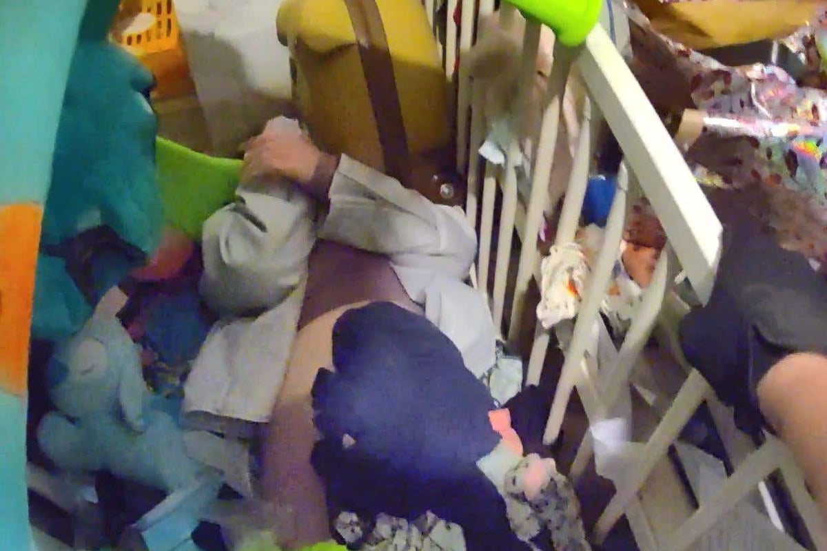 Moment wanted woman is arrested after being found hiding under pile of toys