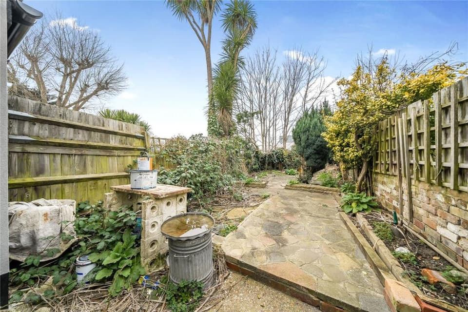 The property has a large paved rear garden