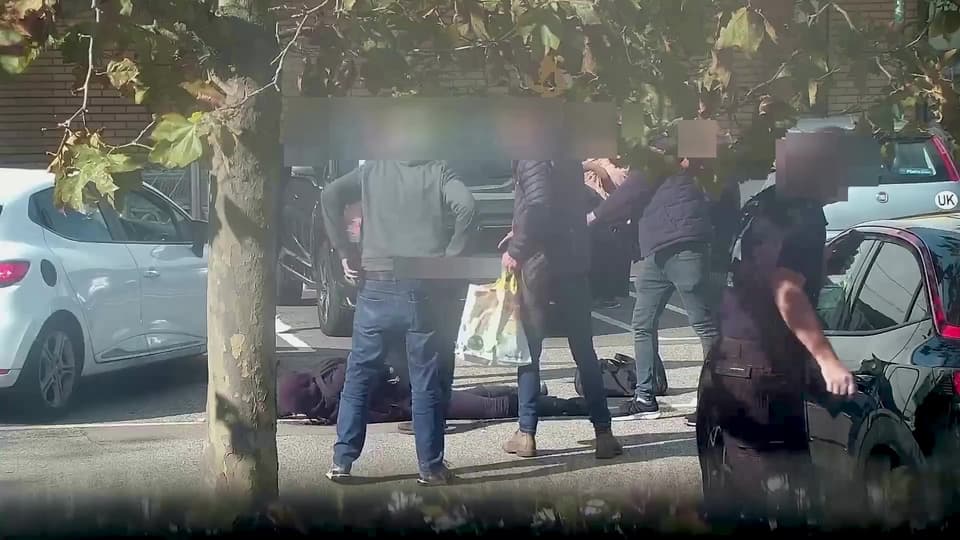 Alfie Coleman lying on the ground as he is surrounded by armed officers in a Morrisons car park on September 29 2023
