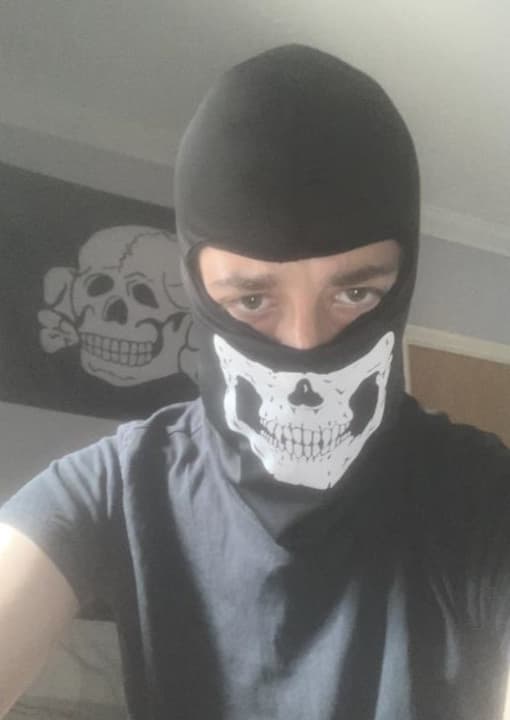 <p>Neo-Nazi Alfie Coleman pictured in a skull mask</p>