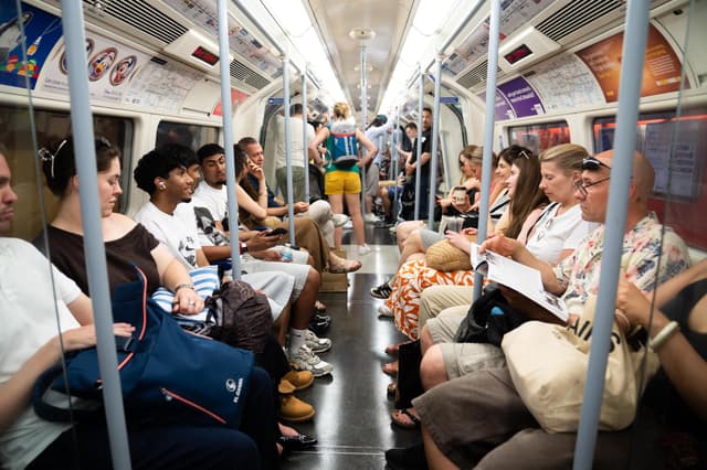 <p>People travel in a busy Jubilee Line train carriage on the London Underground </p>