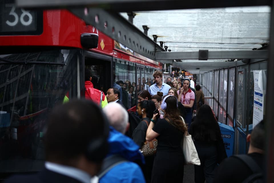 Commuters queue for a red double decker bus outside Victoria train station, in south west London on June 2, 2026, on the first day of two days of London tube strikes by members of the RMT union. (Photo by Henry NICHOLLS / AFP via Getty Images)