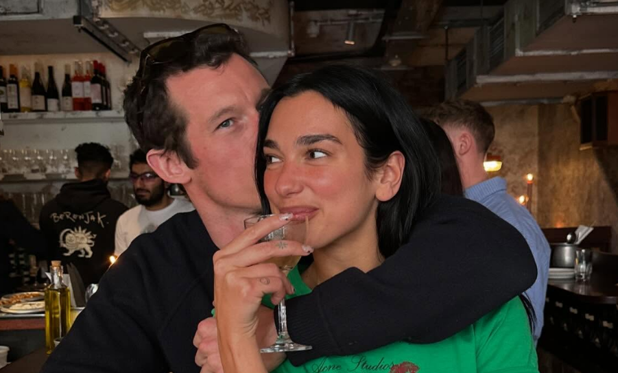 Dua Lipa passionately kisses Callum Turner in behind-the-scenes wedding snaps 