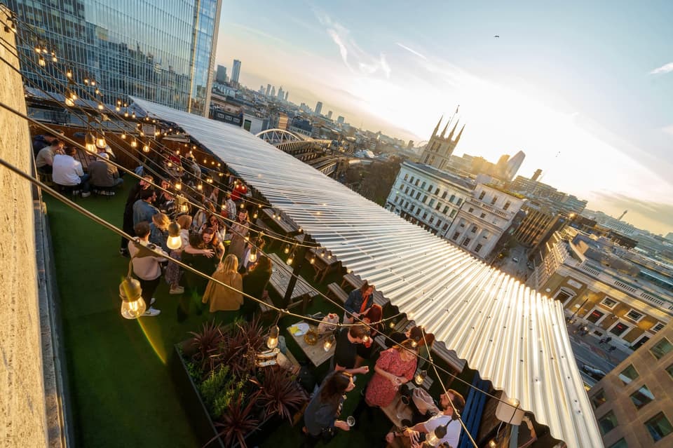 People drinking at London Bridge Rooftop Bar
