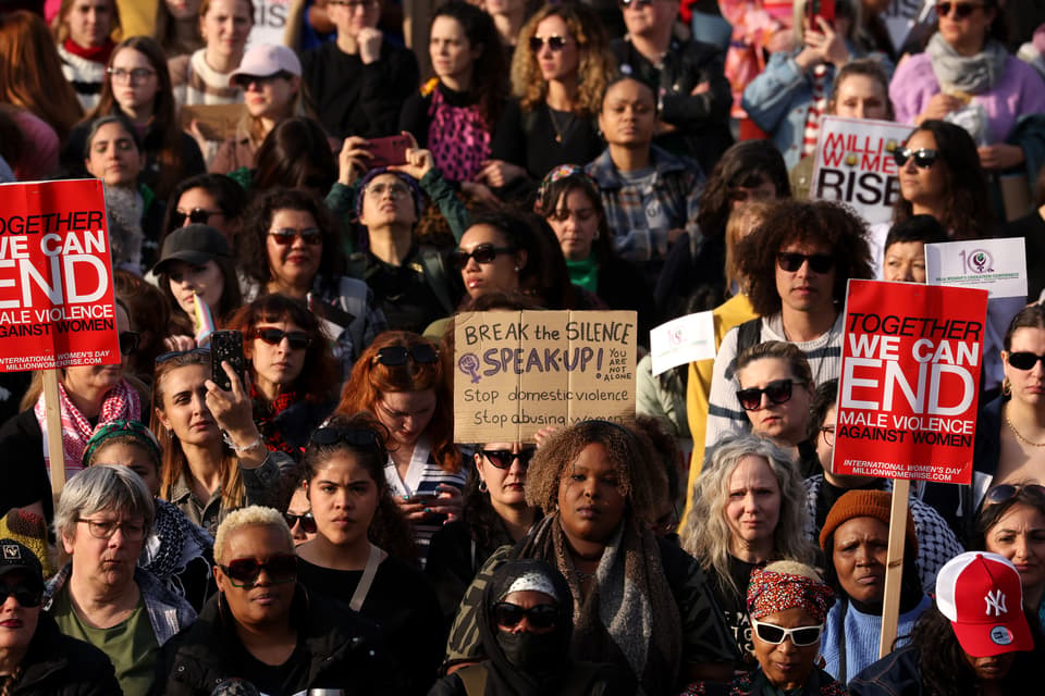 People holding placards gather in Trafalgar Square during a demonstration marking International Women's Day on March 8, 2025 in London