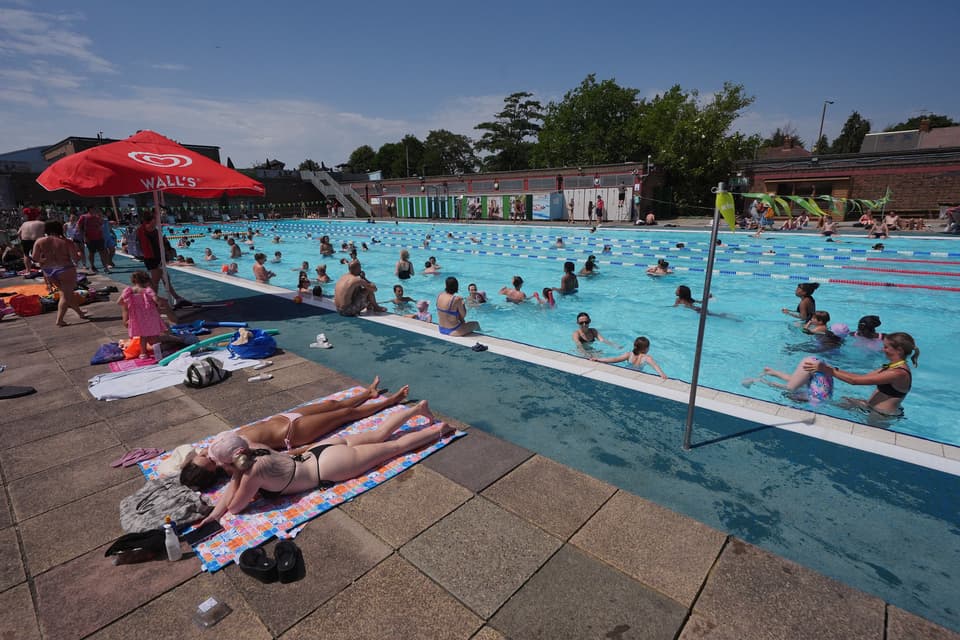<p>Swimmers enjoying the water at Charlton Lido in south east London. A rare red warning for extreme heat has been issued by the Met Office as the UK has sweltered in exceptionally hot and humid conditions. The heatwave, driven by a "heat-dome" settling over western Europe that has brought extreme conditions across the continent, has led to health warnings, school closures and transport disruption. Picture date: Friday June 26, 2026.</p>