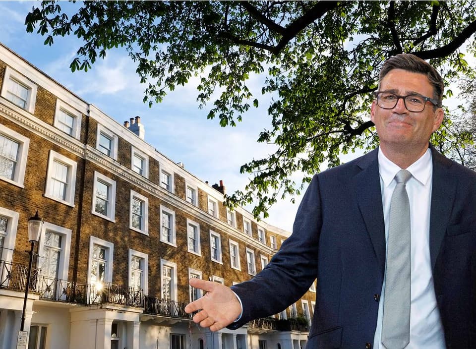 A cutout of Andy Burnham over a row of houses in London