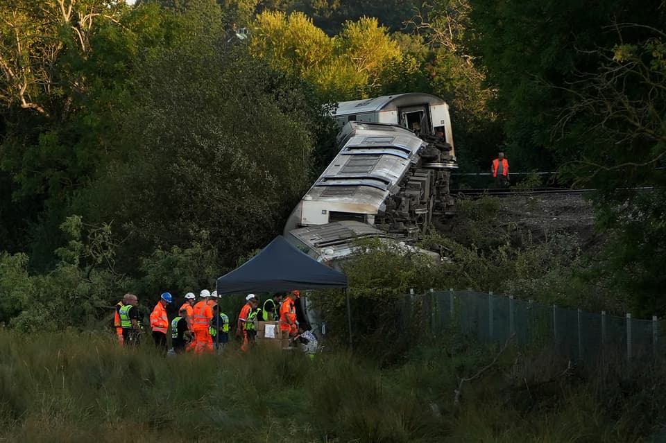 <p>Carriages of a derailed train are pictured on their side, near Lewes</p>