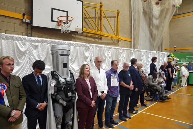 Candidates listen to the declaration for the Clacton by-election count at Clacton Leisure Centre in Essex
