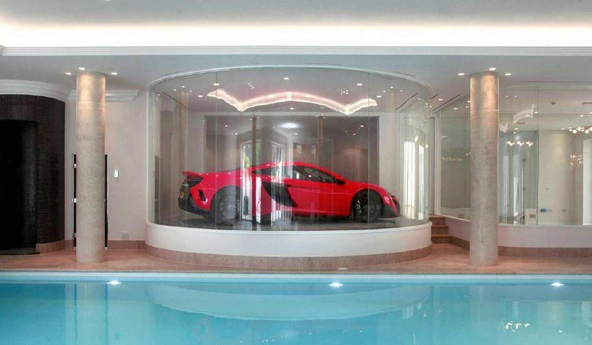 Poolside parking in Virginia Water: £20m mansion in Surrey's millionaires' row has a glass car turntable that lets you admire your sports car while you swim indoors | Homes and Property
