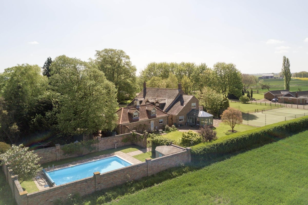 Views for miles: Norfolk farmhouse in extensive gardens that include a tennis court and successful holiday let | Homes and Property