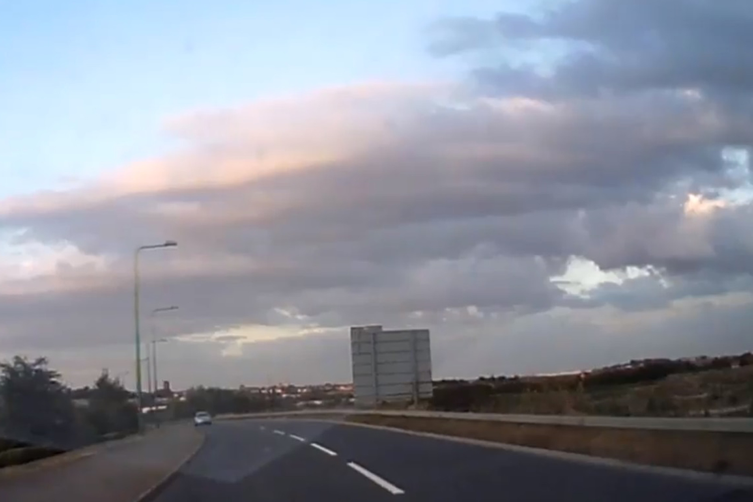 Driver captures moment car hurtles around bend on wrong side of road