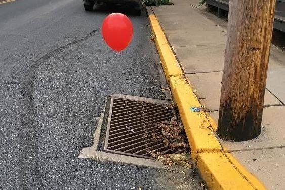Red 'It' balloons tied to town's drains are terrifying police officers | London Evening Standard