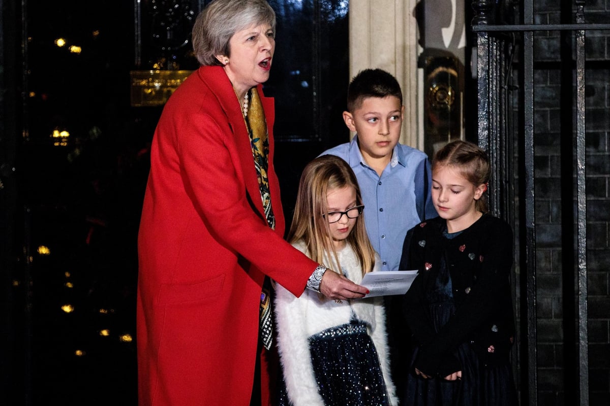 Theresa May sings carols outside No10 on day of Brexit turmoil as she turns on Downing St Christmas lights | London Evening Standard