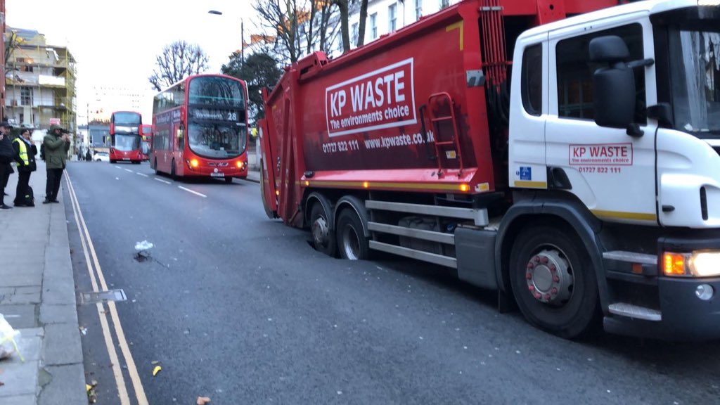 West London street closed after bin lorry stuck in sinkhole