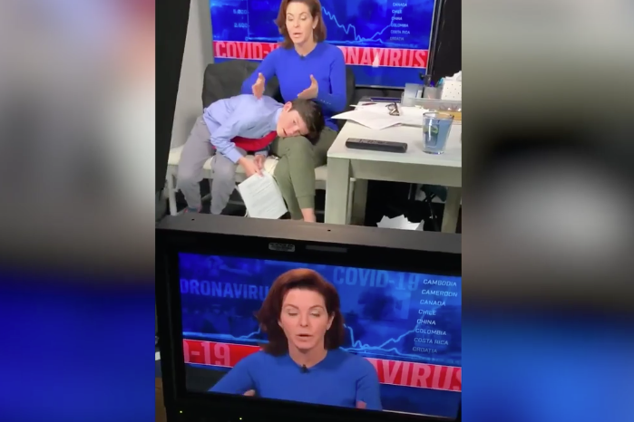 US news anchor presents TV bulletin with son snoozing on her lap | London Evening Standard