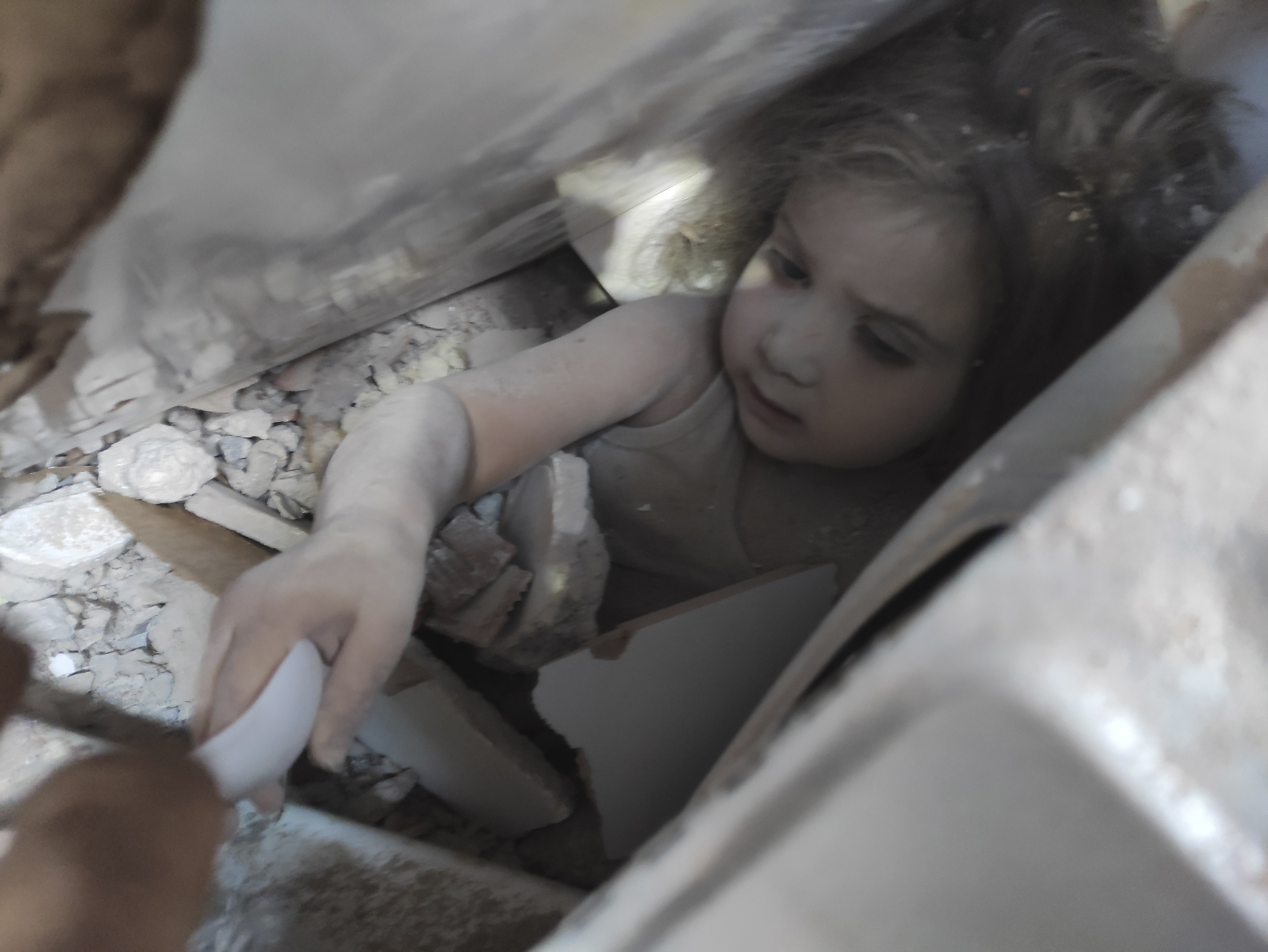  Ayda Gezgin is tended to by a member of rescue services in the rubble of her collapsed building, in Izmir, Turkey