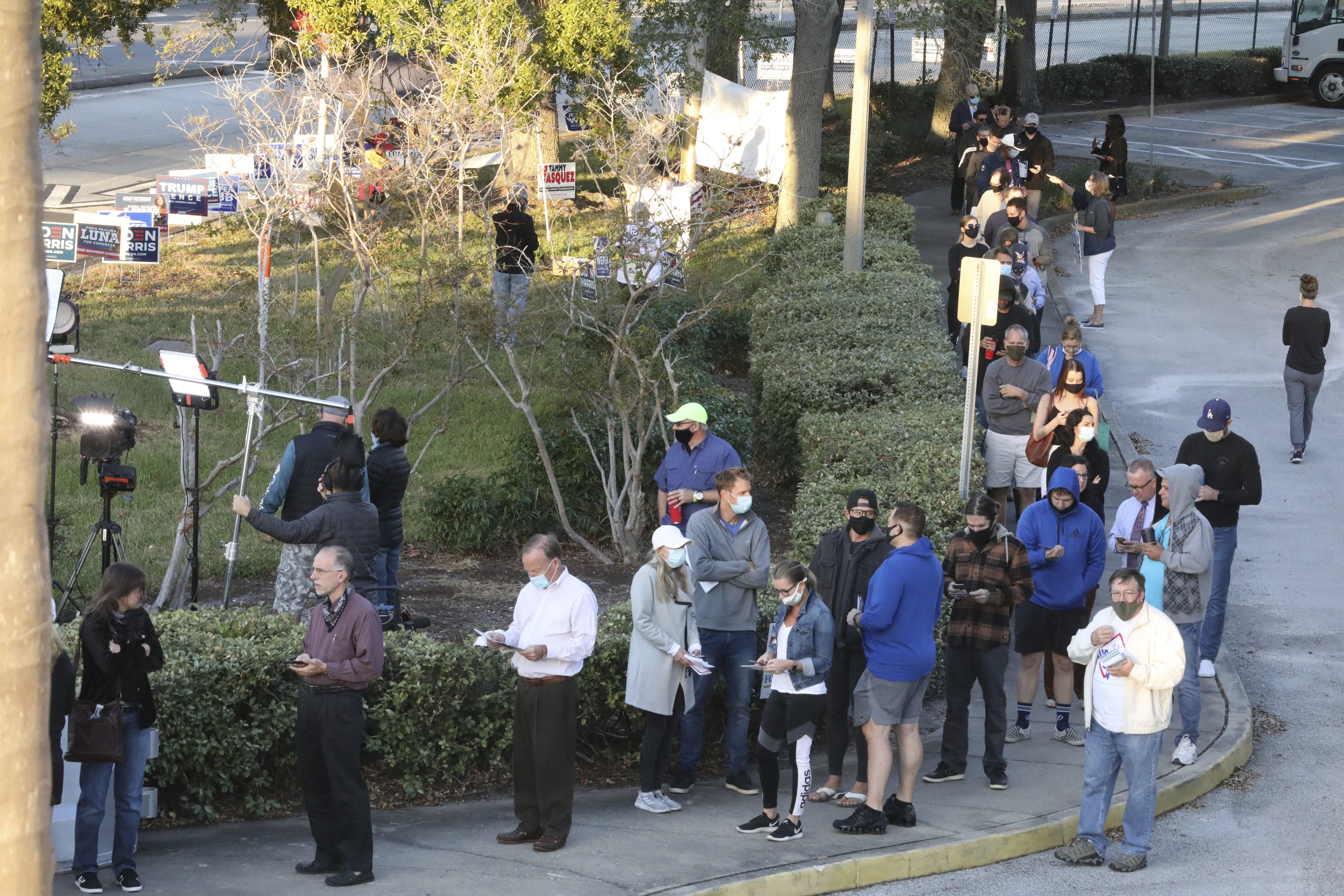 A line of voters forms through the parking lot of the Coliseum Ball Room on Election Day,  St. Petersburg,Fla.,  Tuesday, Nov. 3, 2020 as the polls opened at 7am. 