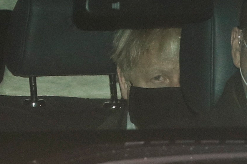 British Prime Minister Boris Johnson sits in a car after arriving from Brussels at RAF Northolt near London