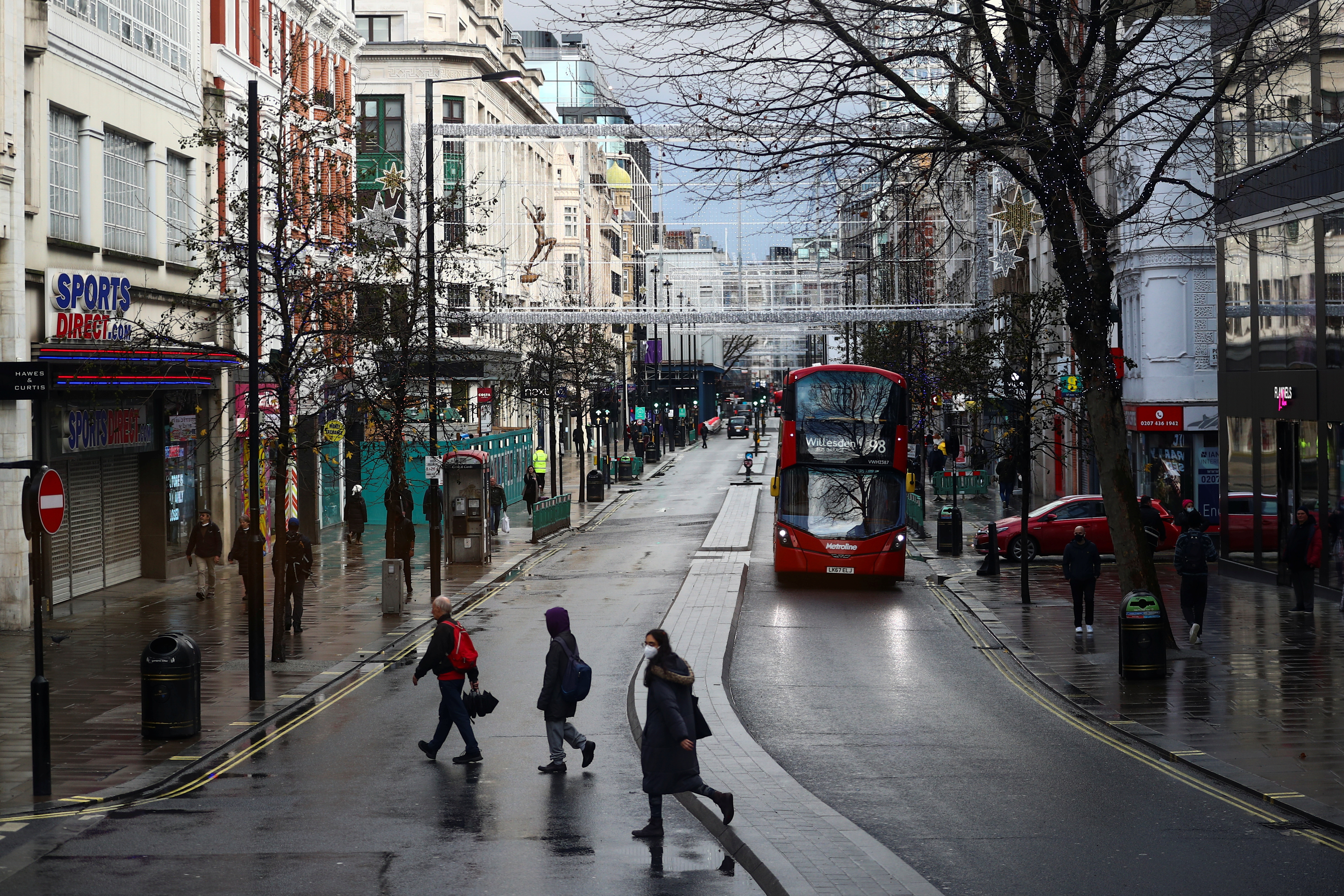 People walk at Oxford Street, in London
