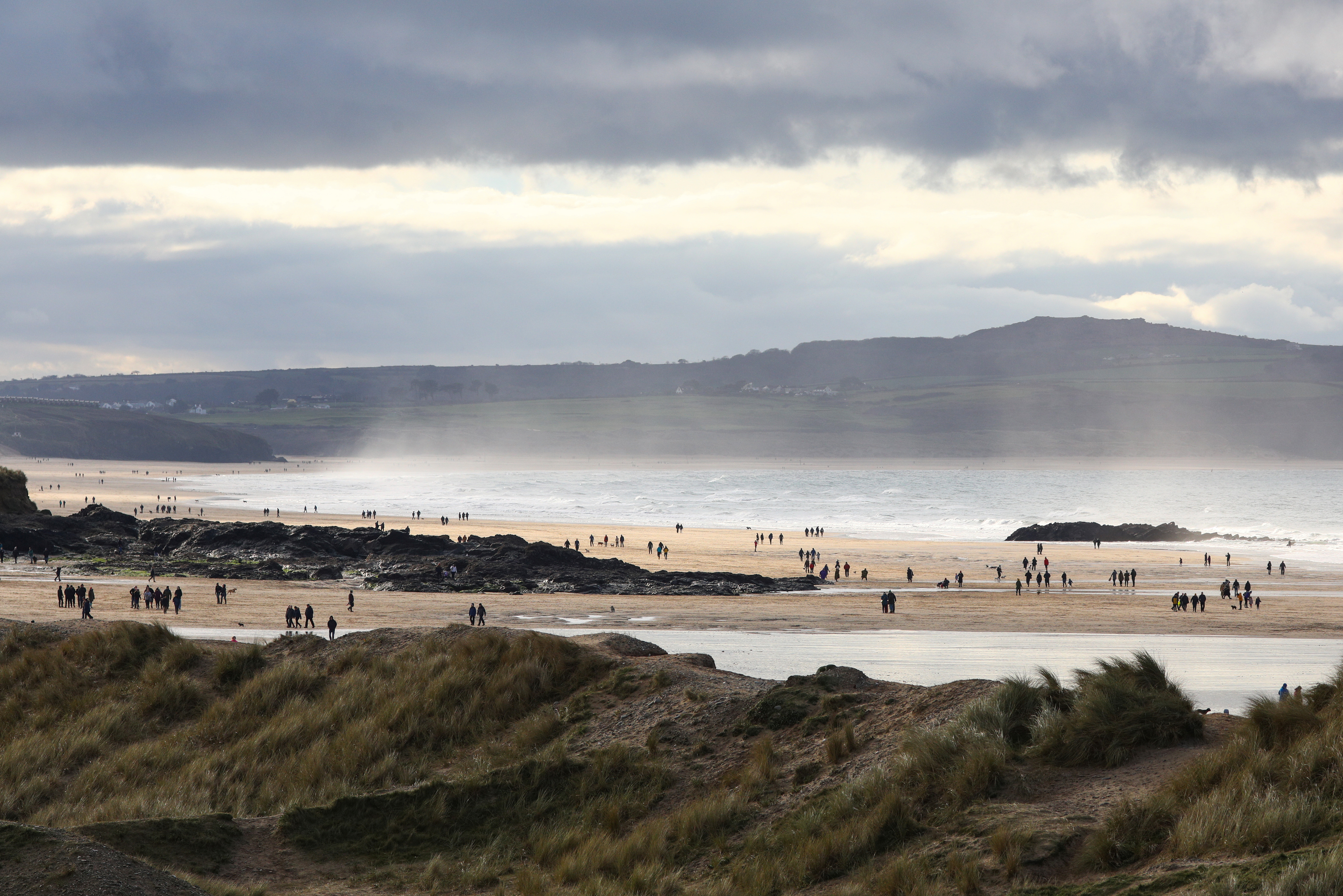 People walk on Godrevy Beach on the New Year's Day