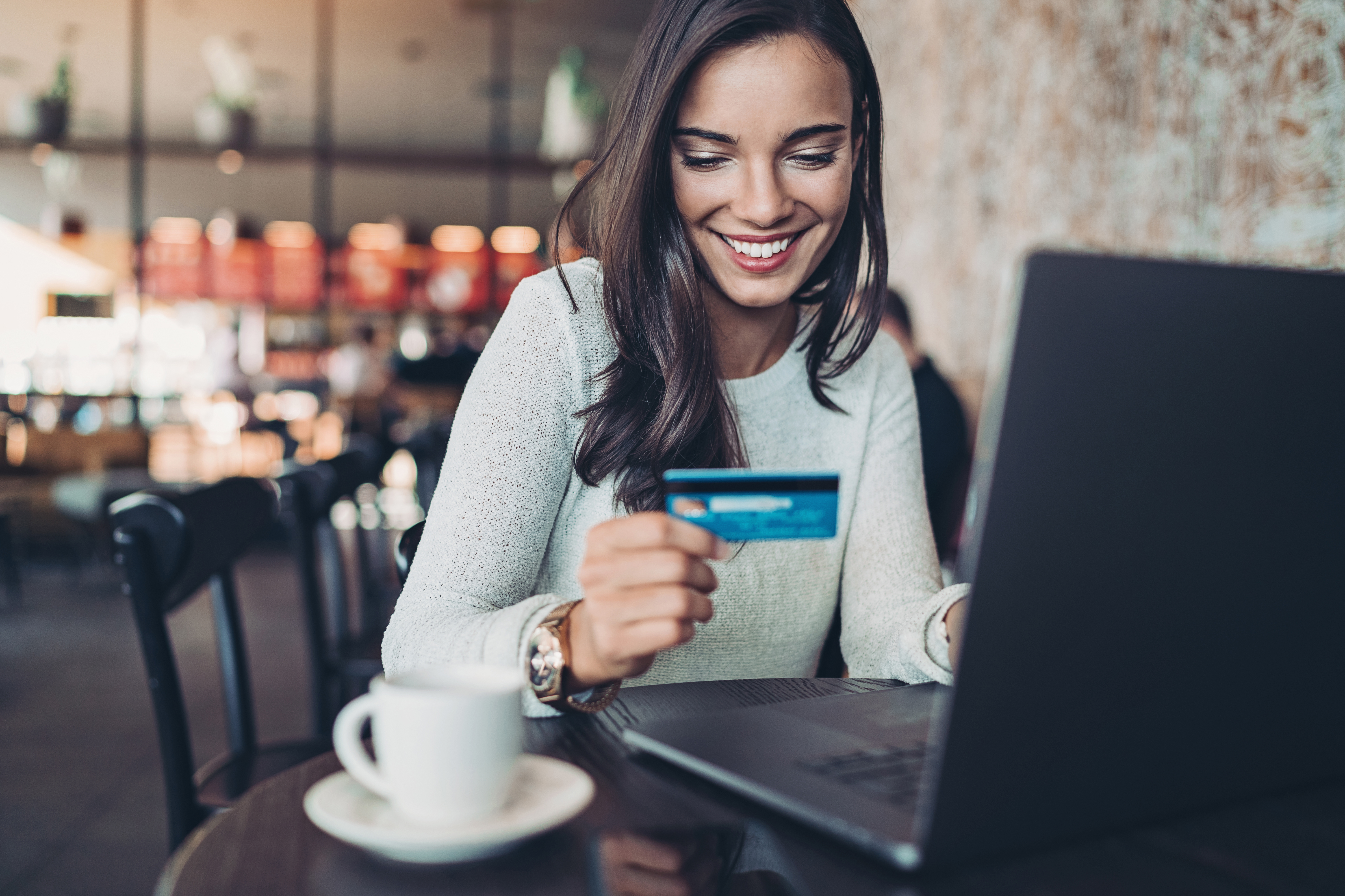 Smiling woman making a credit card purchase