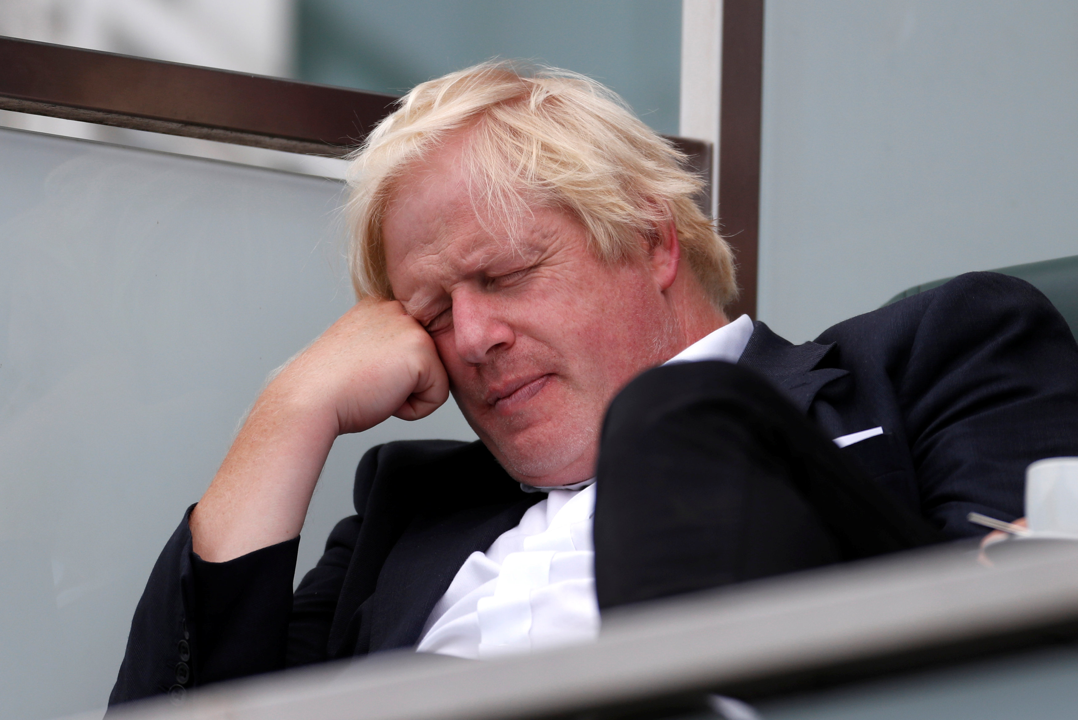 Britain's former Foreign Secretary Boris Johnson takes a nap whilst watching the England cricket team play India at The Oval cricket ground in London