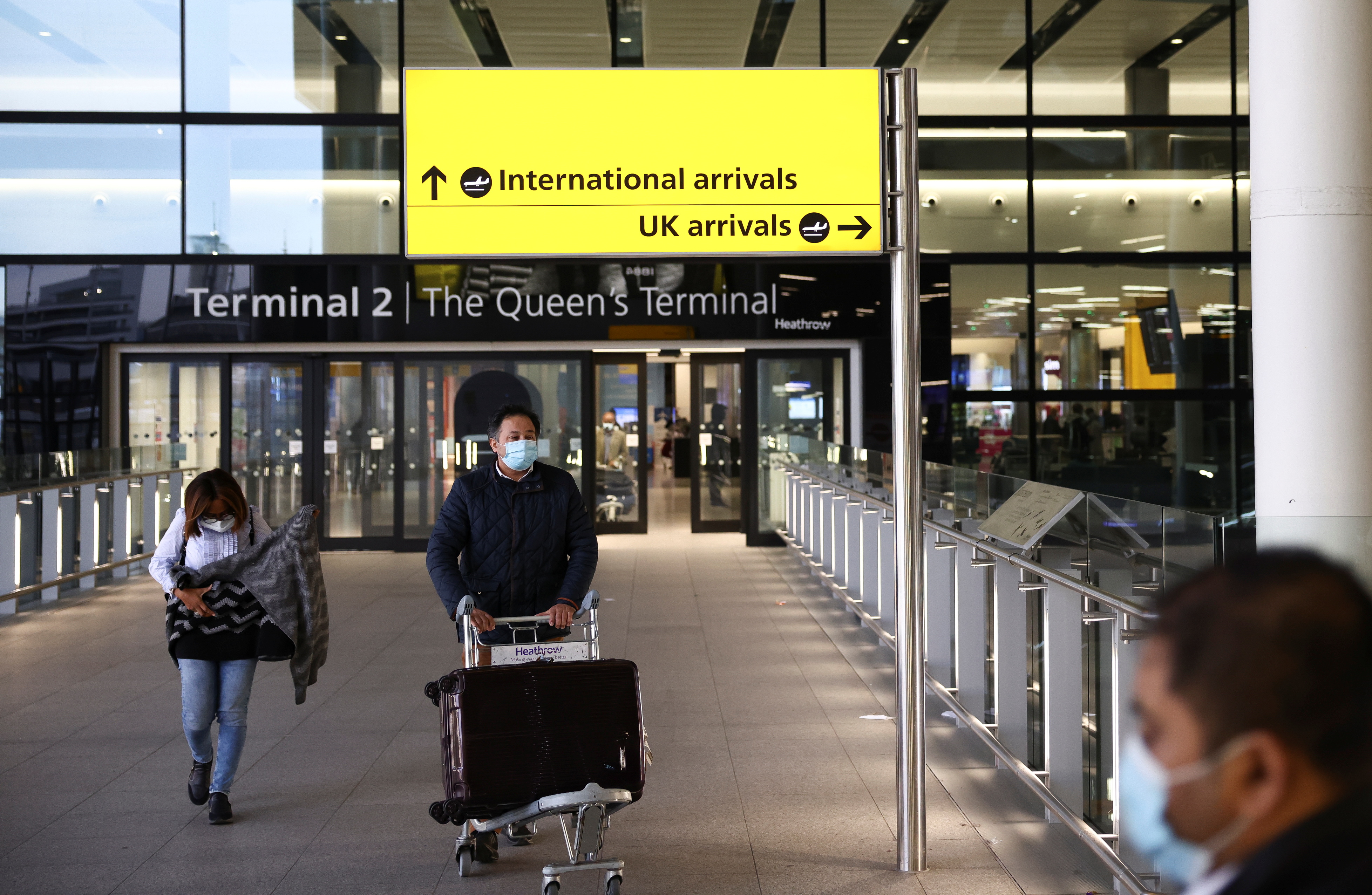 Travellers walk through Terminal 2 at Heathrow Airport, amid the coronavirus disease (COVID-19) outbreak in London