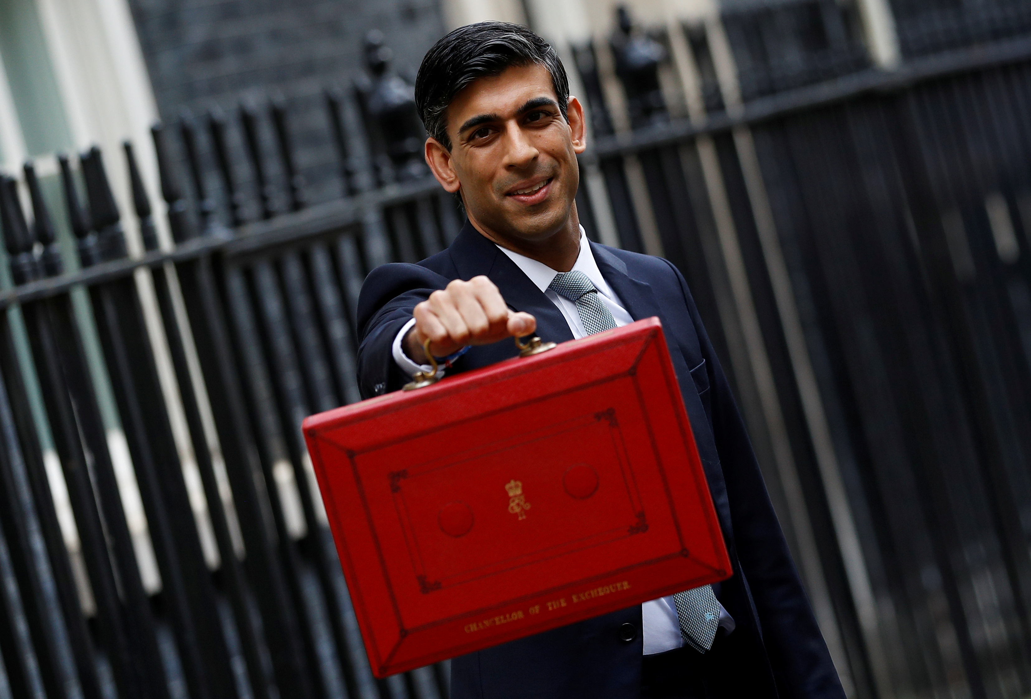 FILE PHOTO: Britain's Chancellor of the Exchequer Rishi Sunak holds the budget box outside his office in Downing Street in London