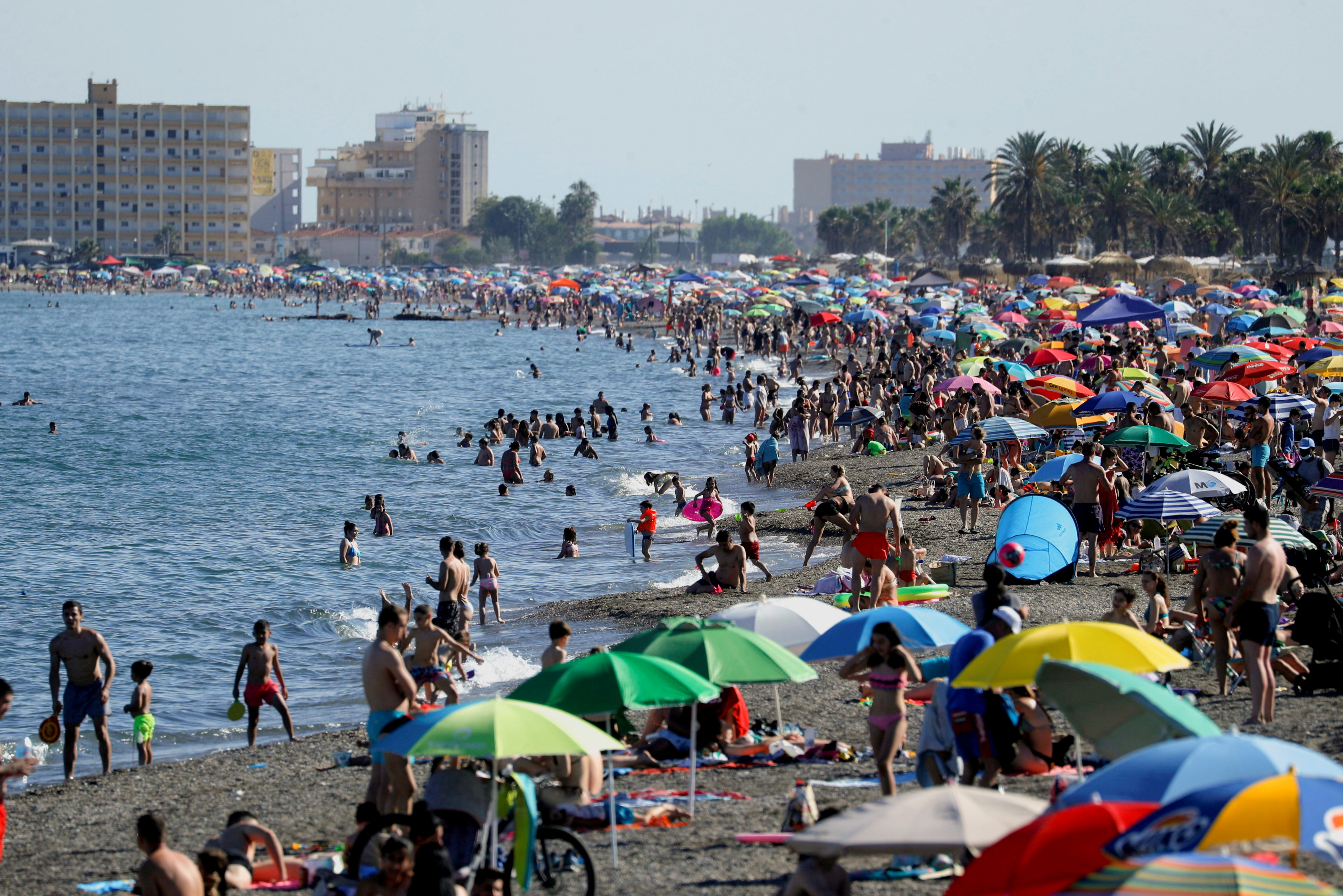 People cool off at the Mediterranean Sea, on La Misericordia beach in Malaga