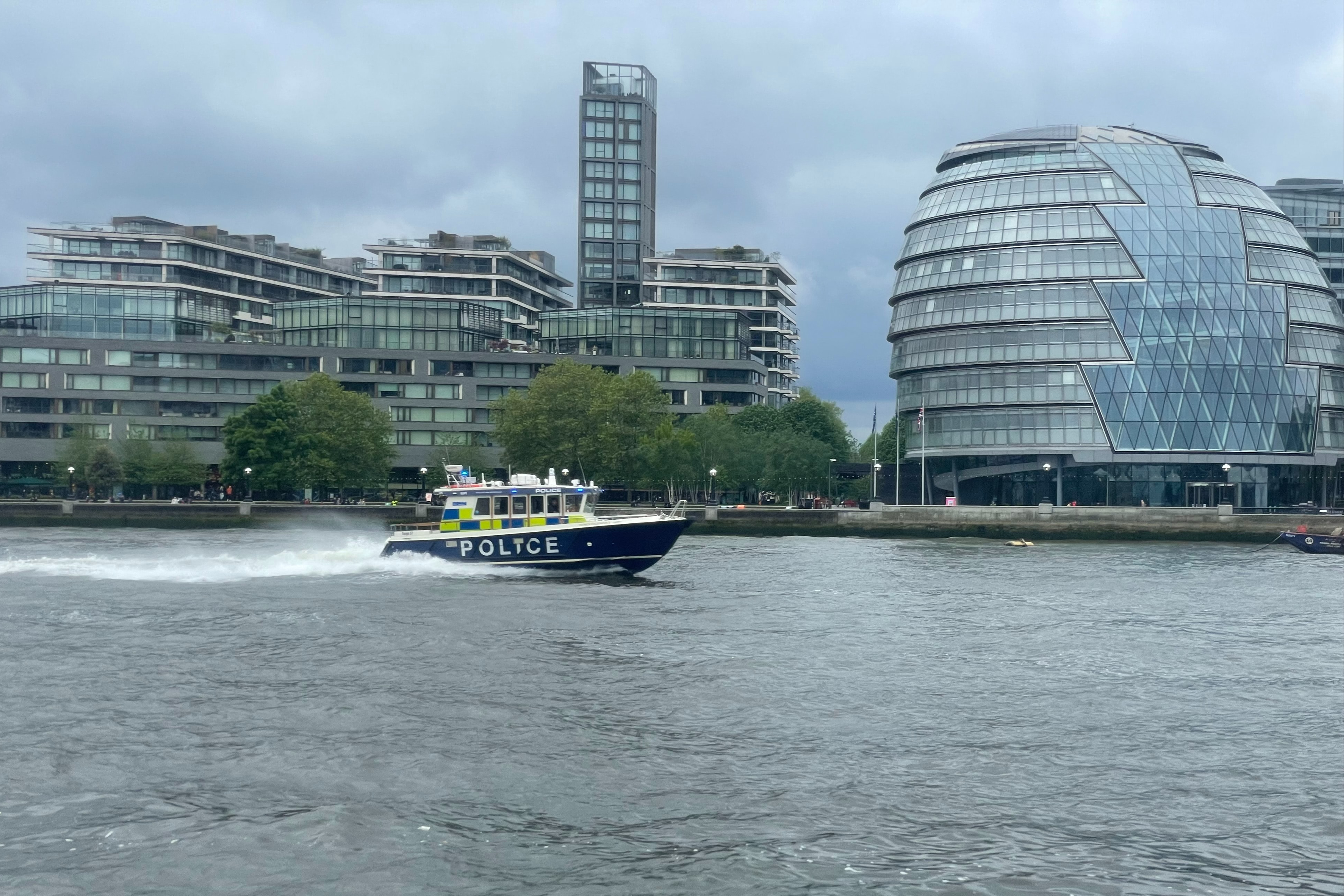 Police boat passes City Hall London Southbank