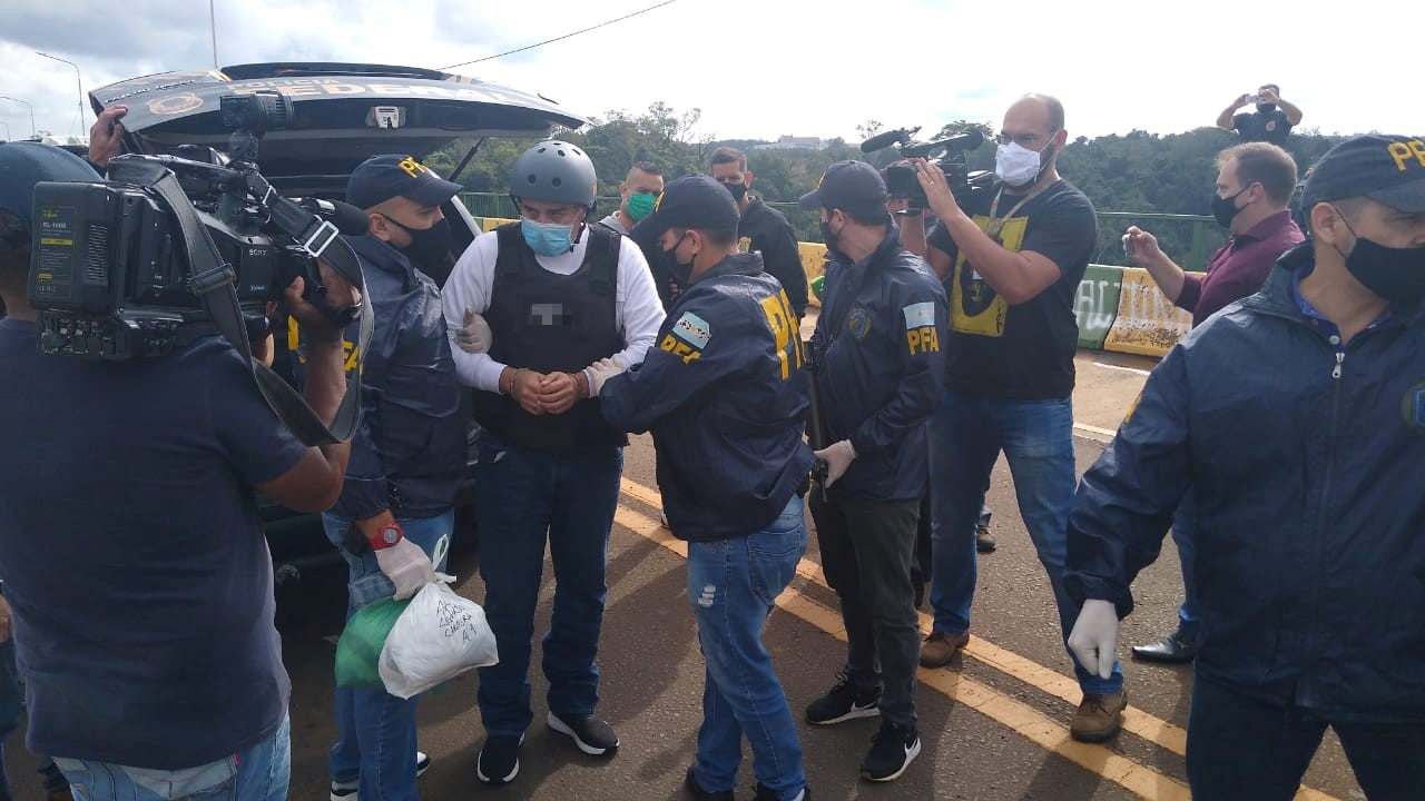Argentine golfer Angel Cabrera is led handcuffed by police officers after being extradited from Brazil