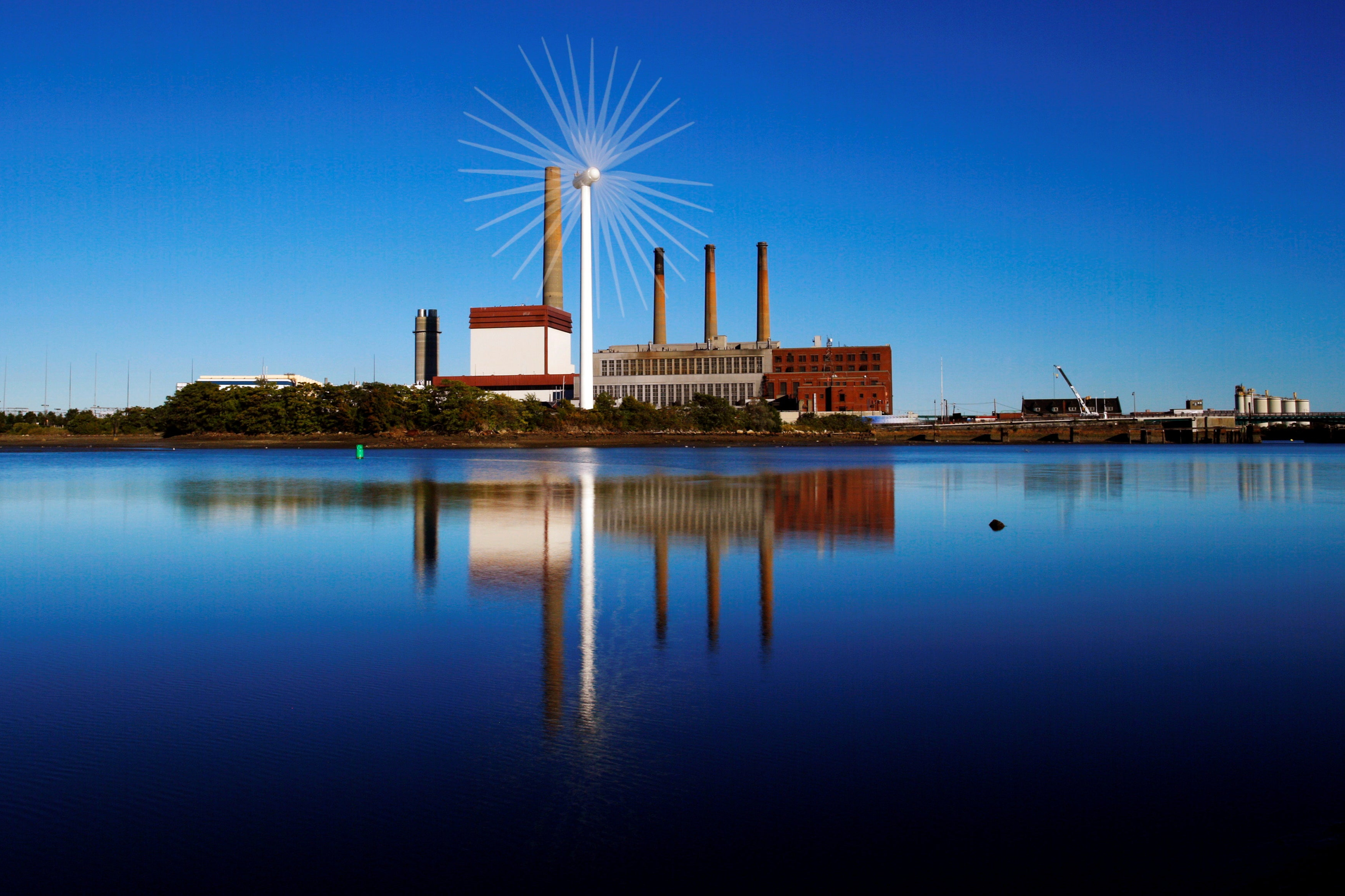 A Massachusetts Water Resources Authority wind turbine turns in front of a 1951 megawatt fossil fuel power plant 240621