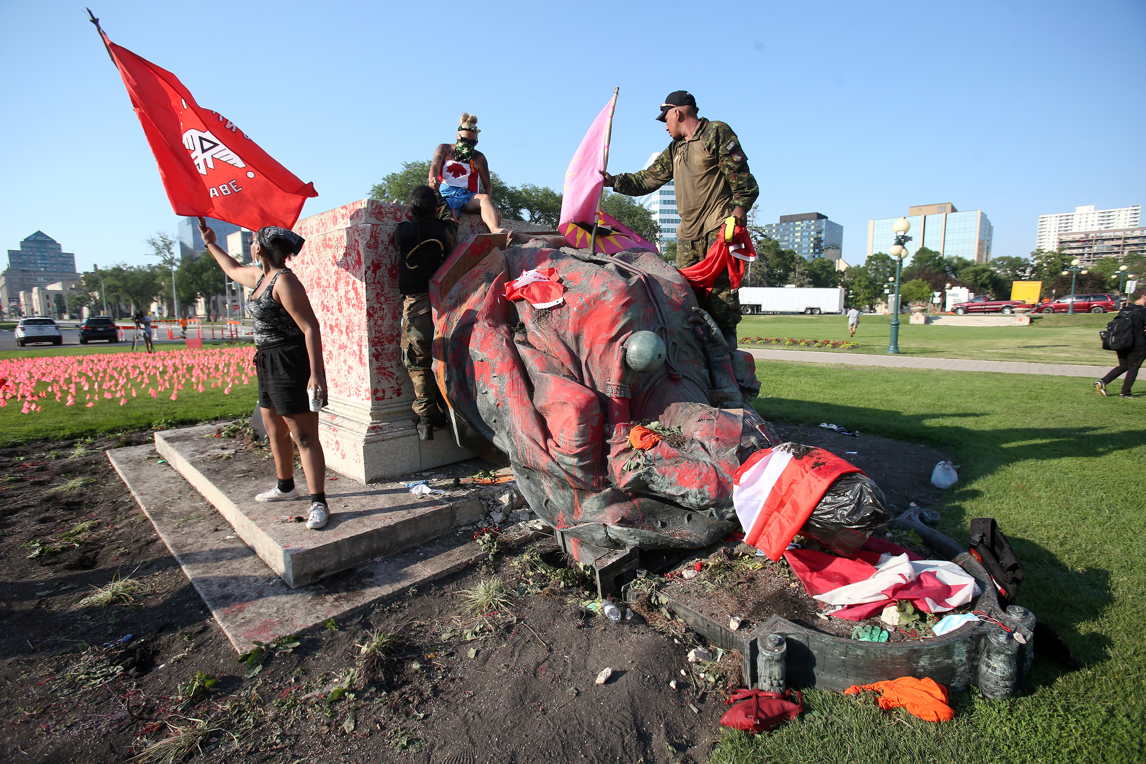 A defaced statue of Queen Victoria lies after being toppled during a rally on Canada Day in Winnipeg