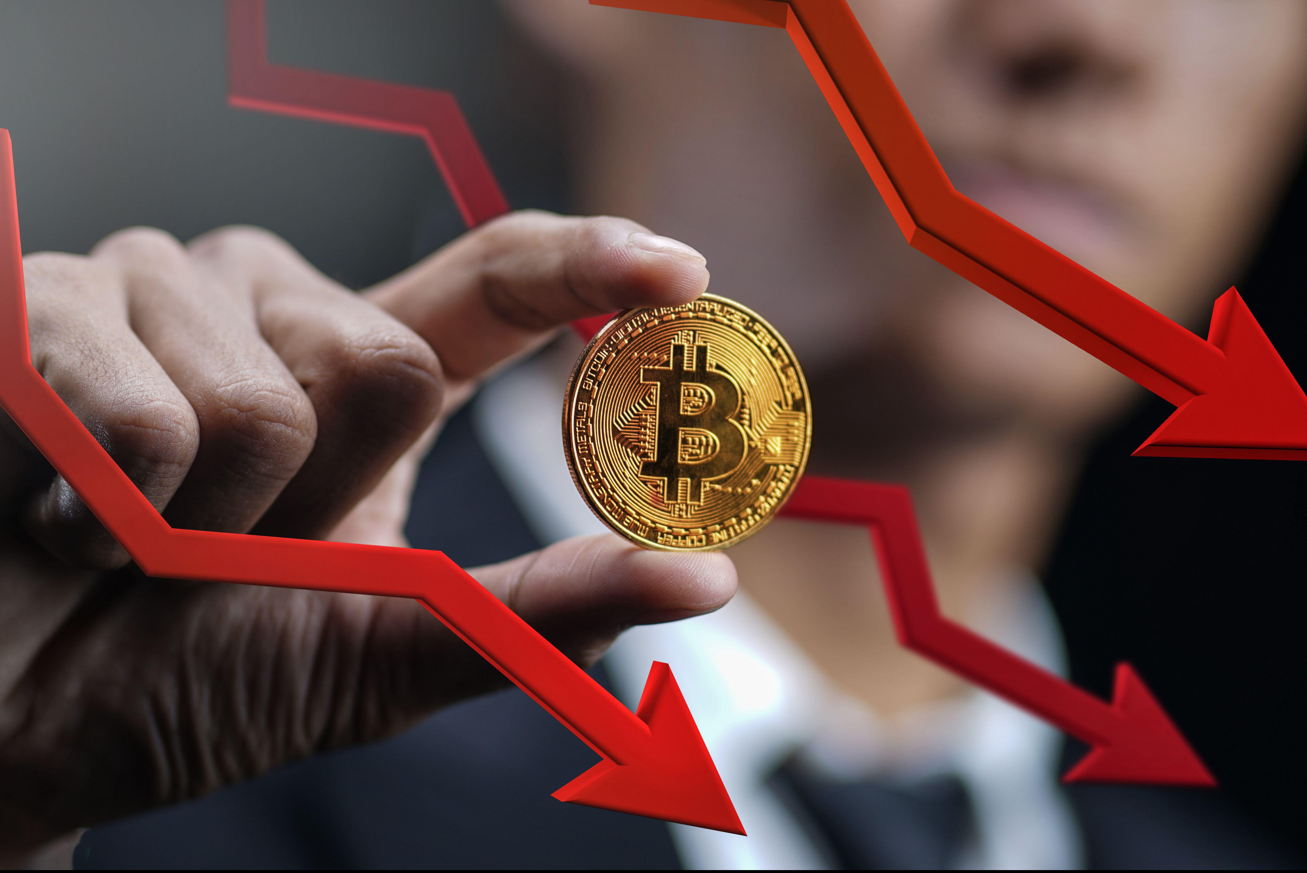 Bitcoin Price Falling Down. Businessman Holding Bitcoin With Red 3D Arrow Down