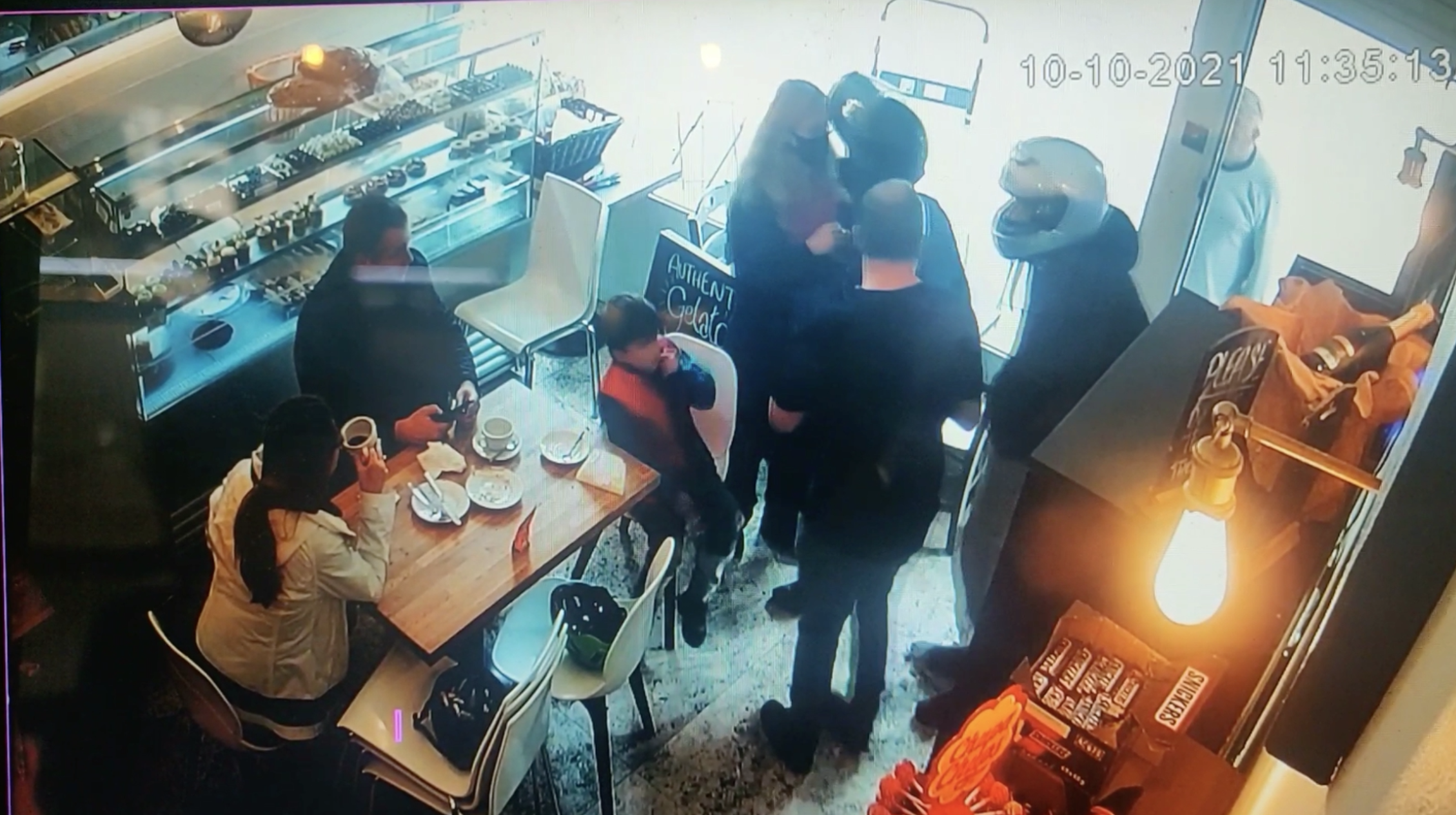 GRABS: Moped thugs throw chair at shop window