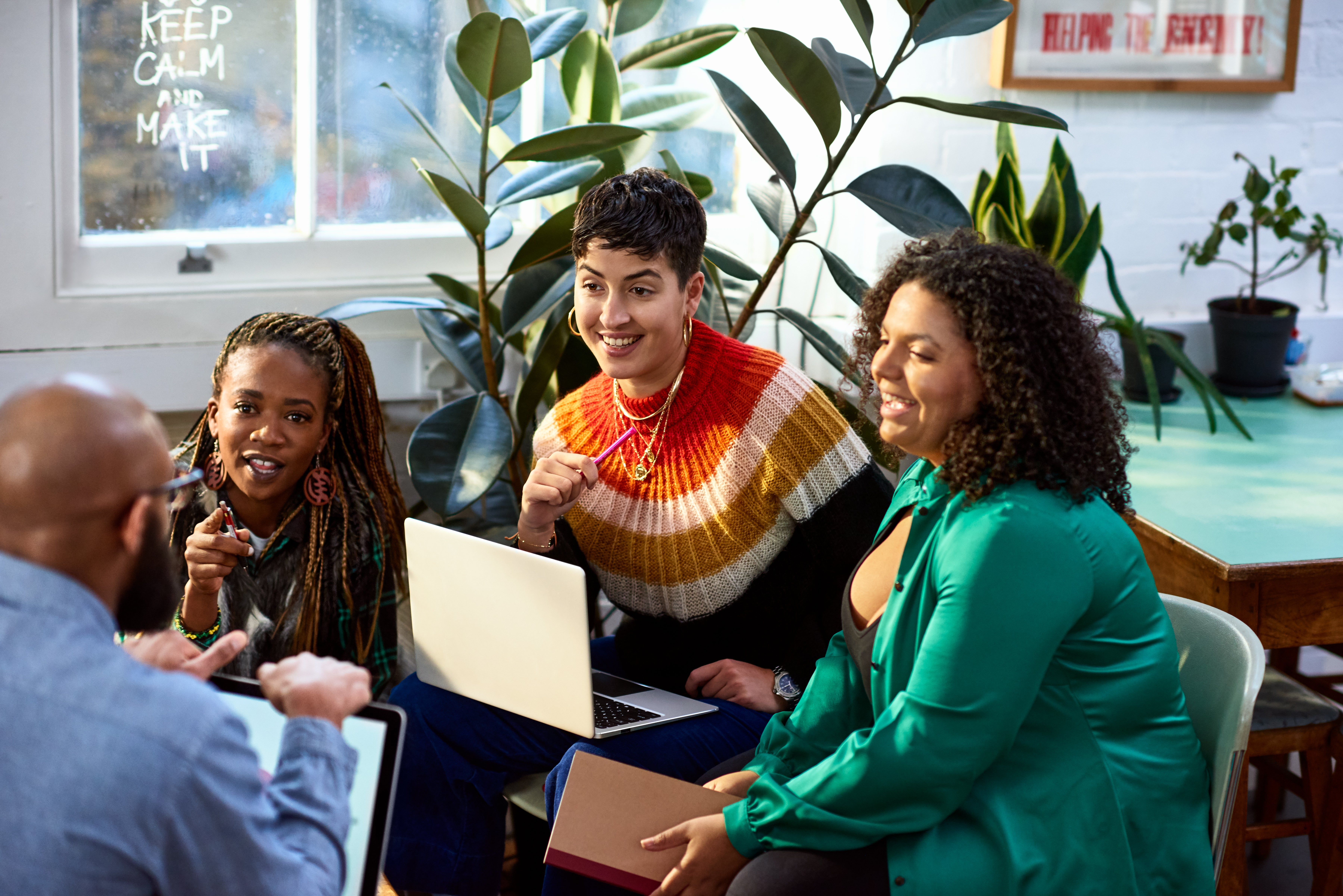 Business women talking to male colleague, informal meeting