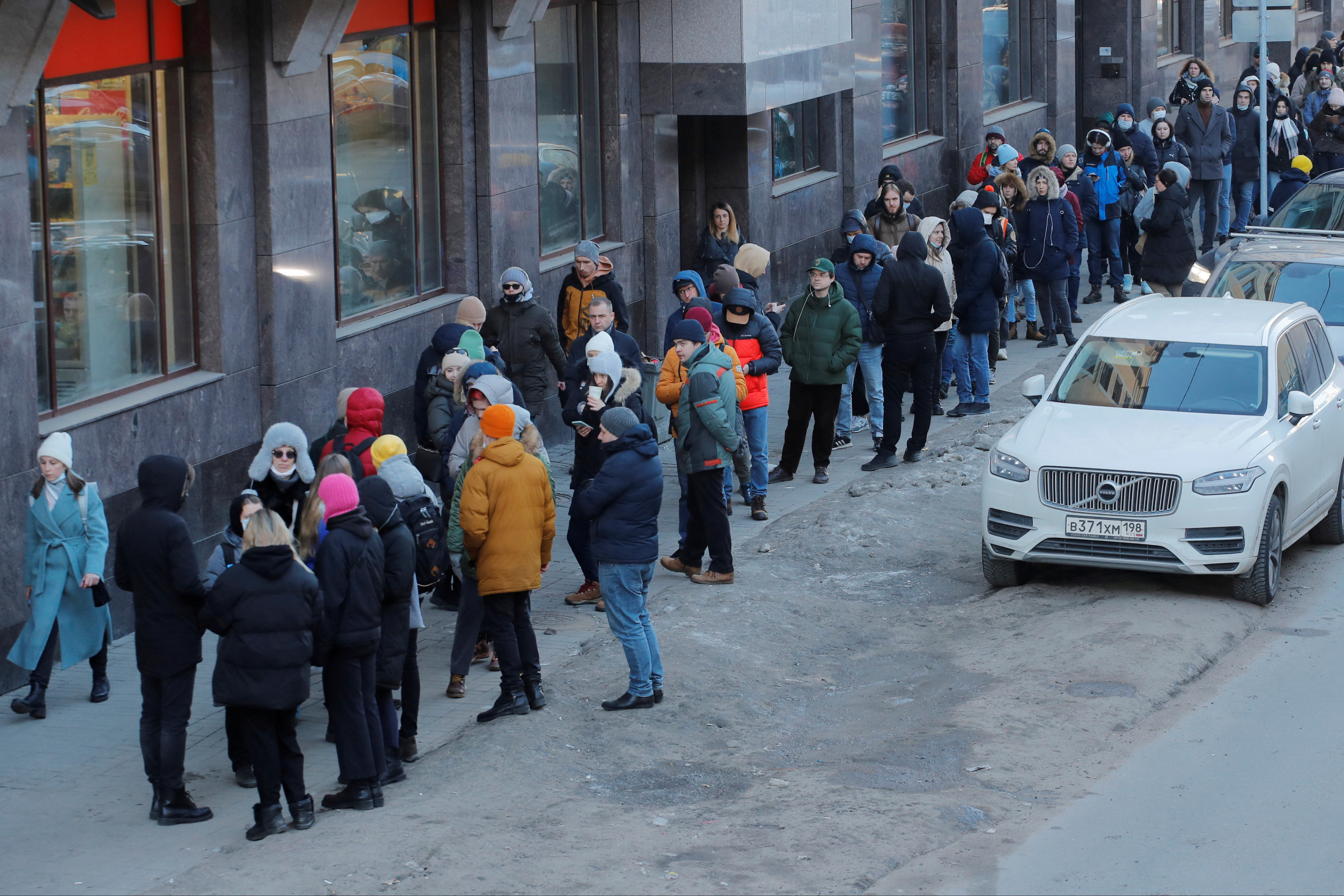 People stand in line to use an ATM money machine in Saint Petersburg
